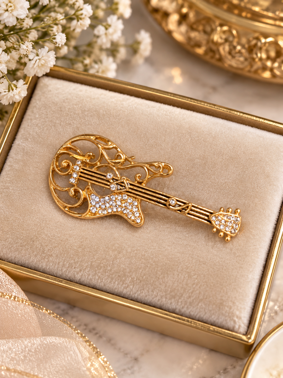 (J9) Gold-tone violin brooch with sparkling diamante detailing. Approx. 5 cm × 3 cm