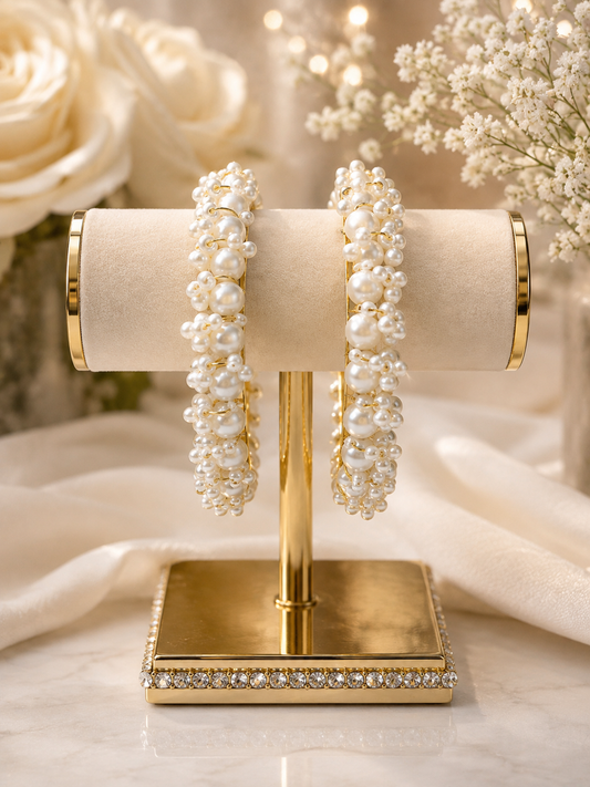 (B21) Elegant pearl statement bangles featuring beautiful clusters of lustrous ivory pearls set on a polished gold-tone base. A luxurious, eye-catching design  size 2.8