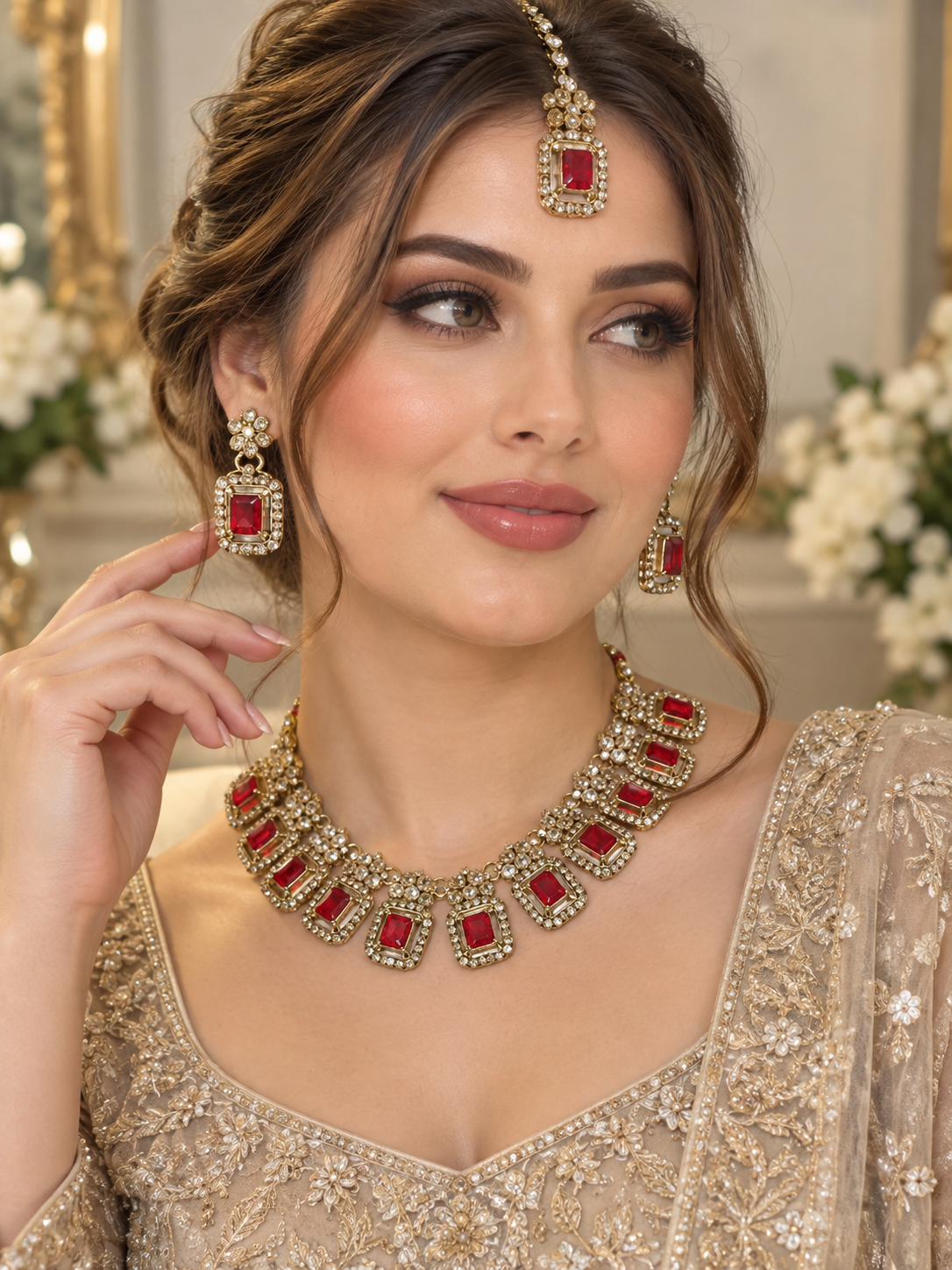 (J2)  Elegant gold-red toned earrings, tikka, and necklace set featuring teardrop-shaped stones surrounded by sparkling crystals