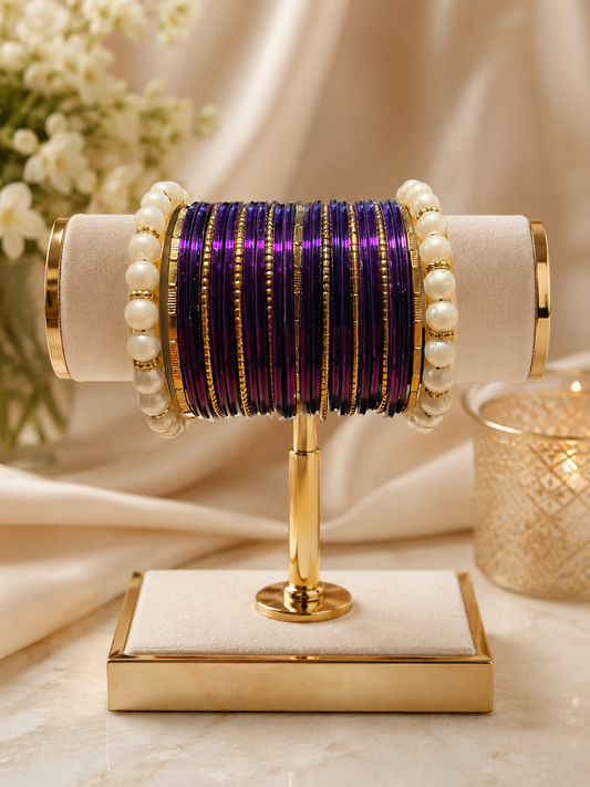 (B7) Elegant purple and gold bangle set featuring shimmering metallic bangles, delicate gold detailing and beautiful pearl accents. A timeless statement set size 2.4