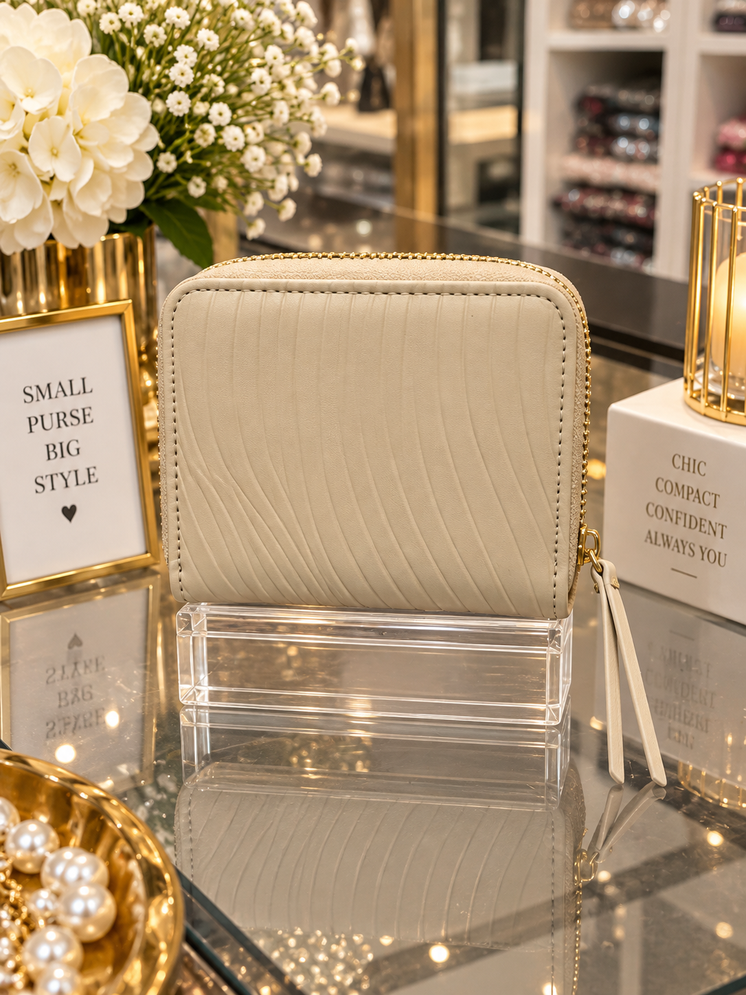(365) Elegant cream compact purse with a chic textured finish, gold zip detailing and multiple card slots. Stylish, practical and perfect for keeping everyday essentials organised