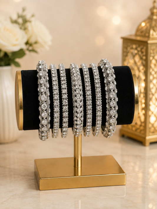 (B25) A stunning silver-tone bangle set beautifully embellished with sparkling diamanté stones. Featuring a mix of delicate and statement designs for an elegant, luxurious finish. Size 2.8