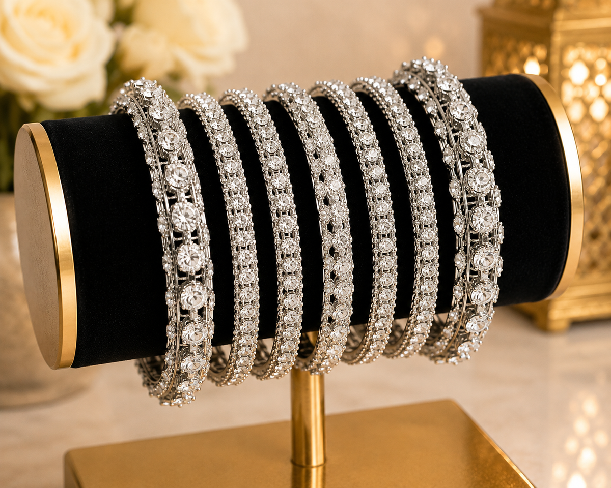 (B25) A stunning silver-tone bangle set beautifully embellished with sparkling diamanté stones. Featuring a mix of delicate and statement designs for an elegant, luxurious finish. Size 2.8