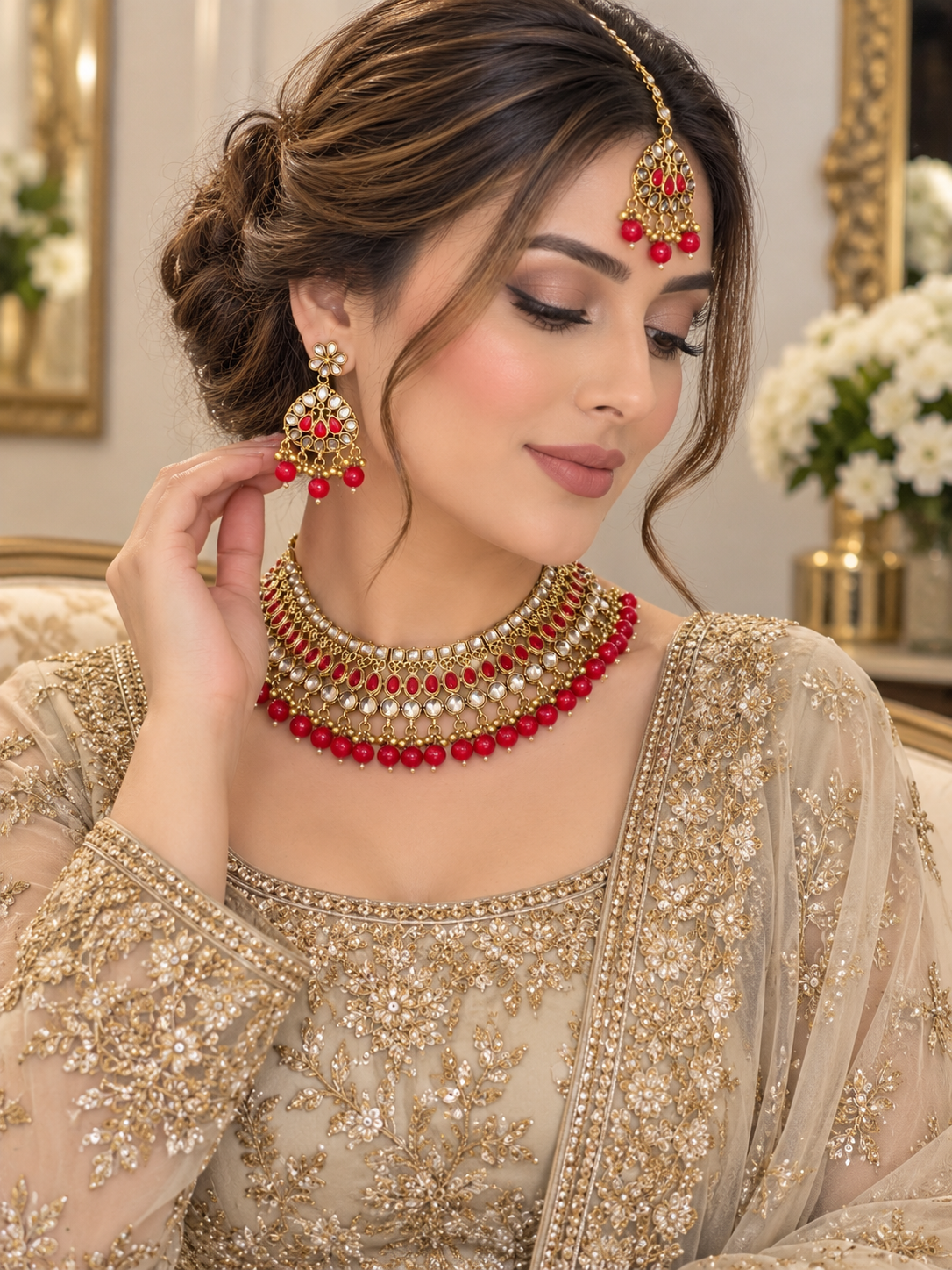 (J7) Elegant gold-tone jewellery set with red stones, sparkling details and matching tikka and earrings. Perfect for weddings and special occasions