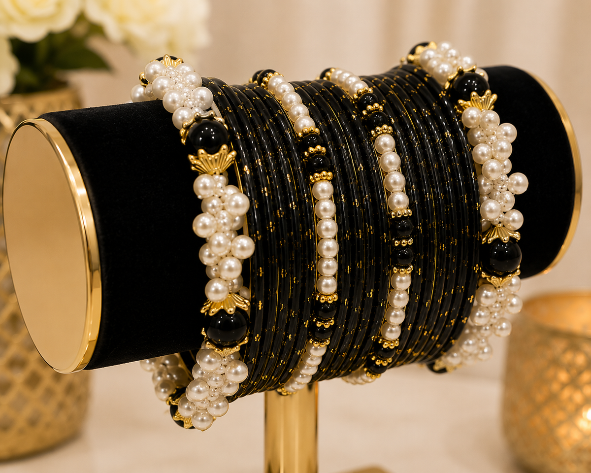 (B17) Elegant black and gold bangle set featuring delicate gold detailing, glossy black beads and beautiful pearl clusters. A striking traditional design size 2.4